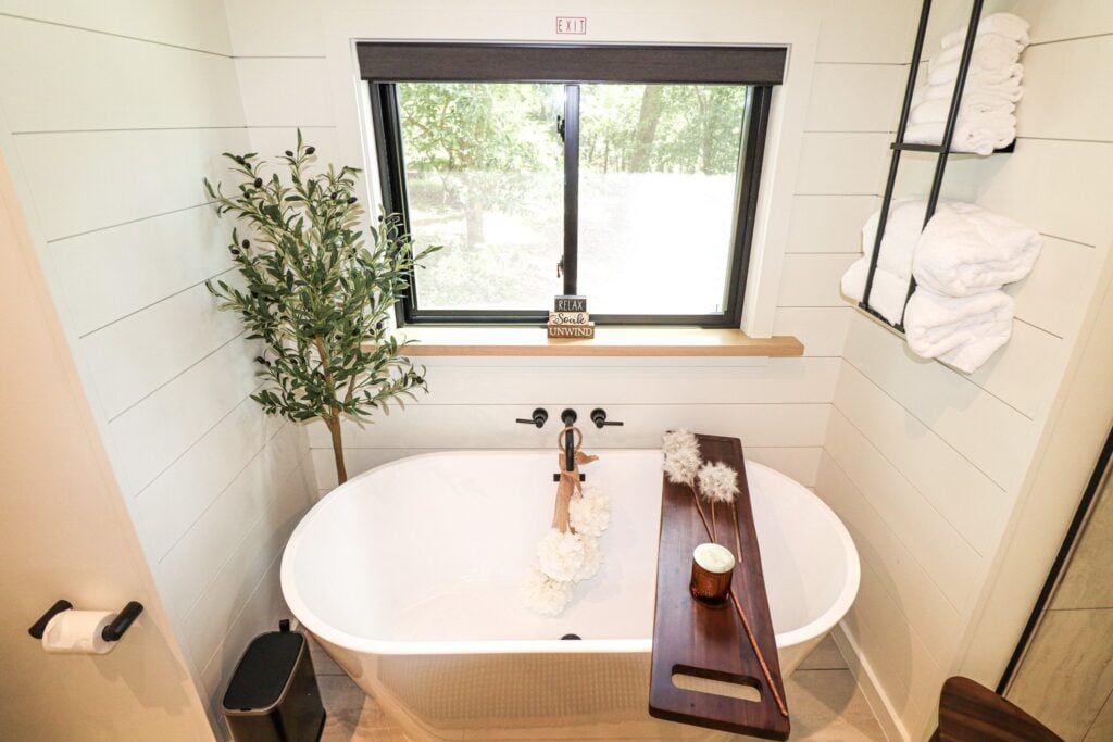 The bathroom with a freestanding soaking tub beneath the window