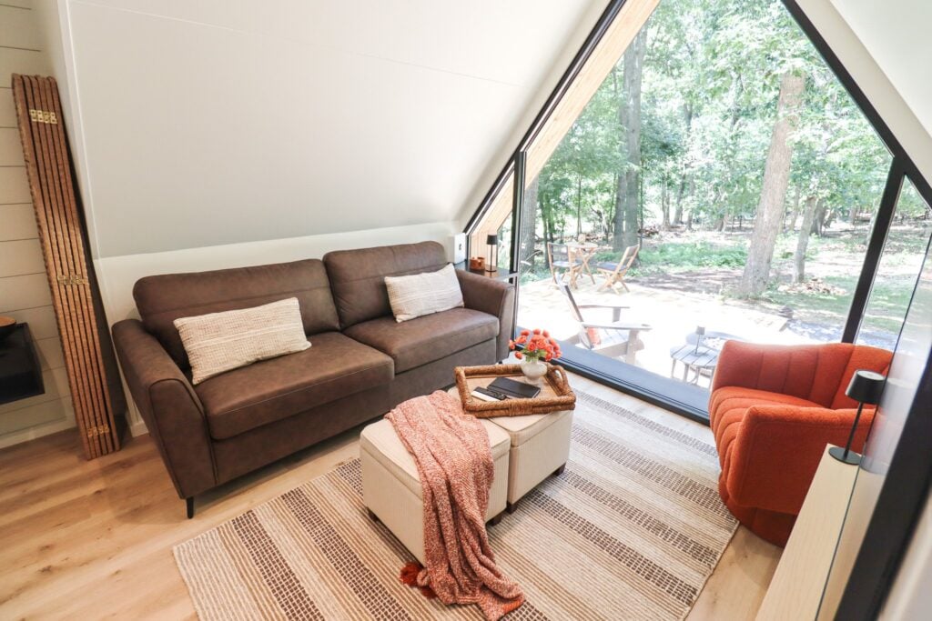 The living area looking out through the full-height gable window into the trees